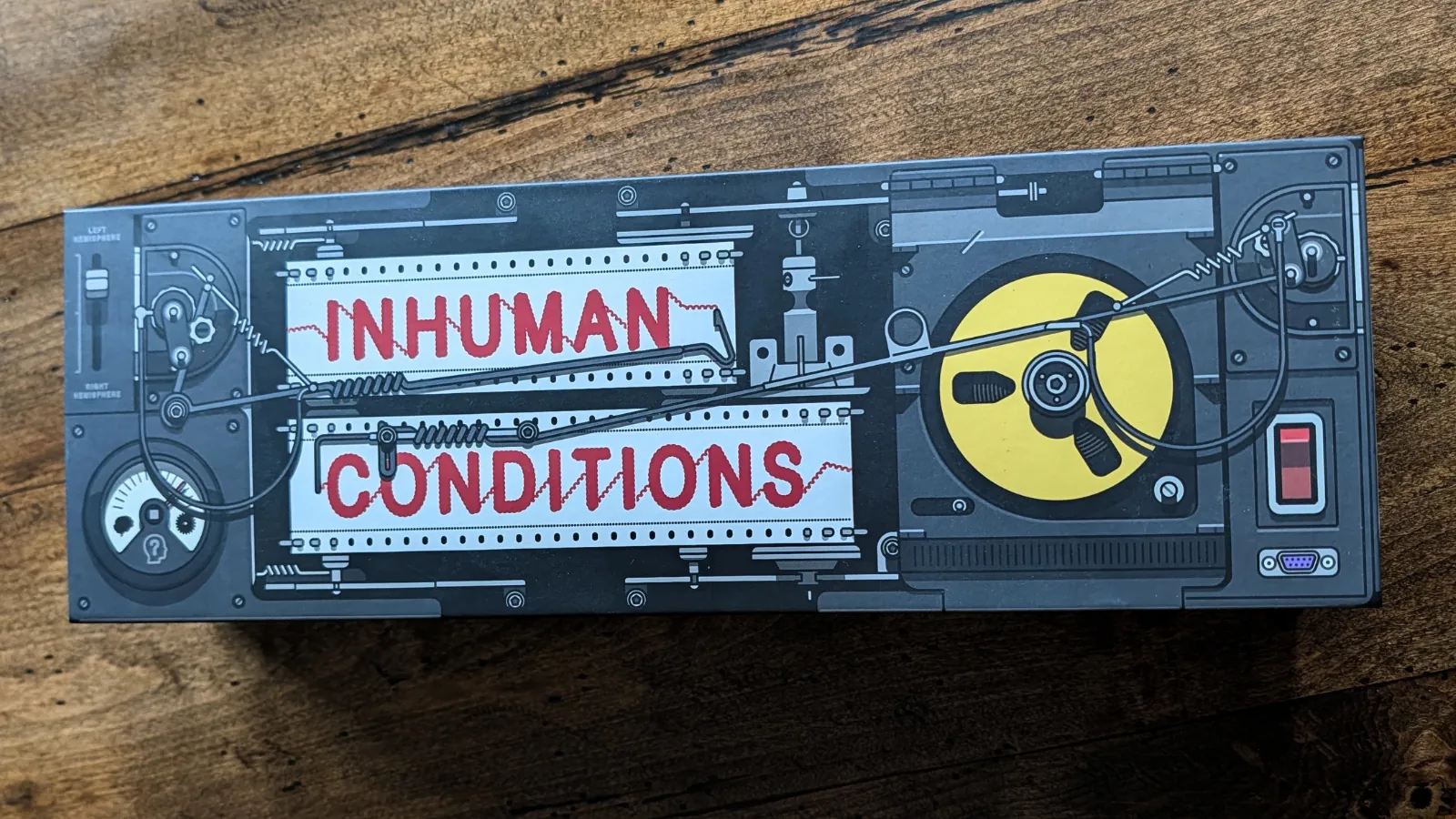 The outside of the box for Inhuman Conditions, a social deduction game for as few as two players.